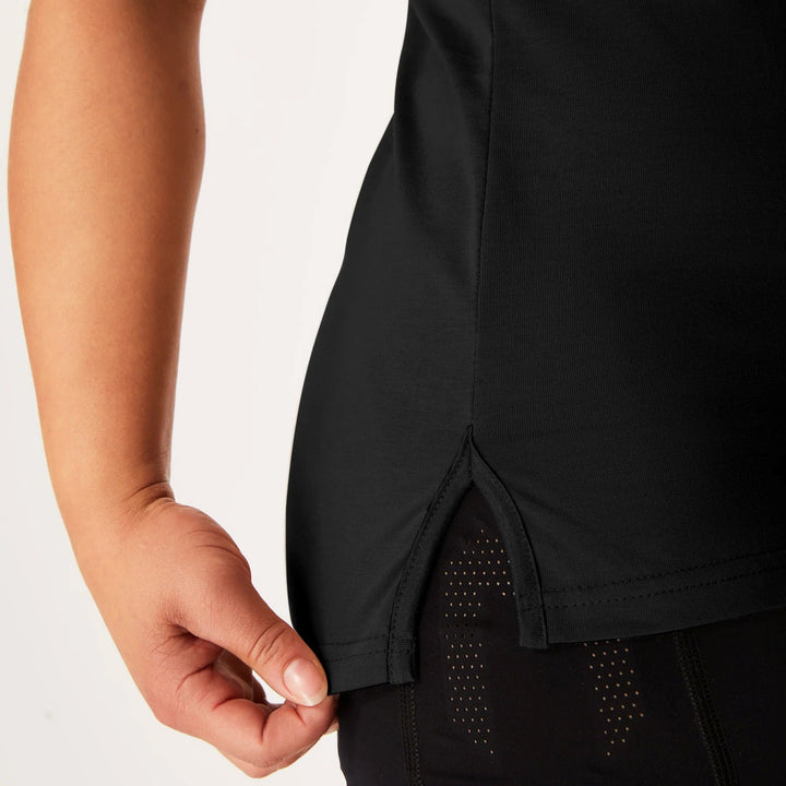 SBD Phantom Tank – athletic cotton tank for strength training & performance - cropped view of split hem on woman